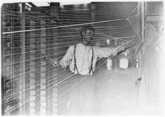 Illustrative photo of a warper at his machine.